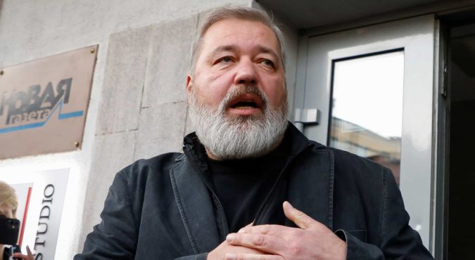 Russian investigative newspaper Novaya Gazeta's editor-in-chief Dmitry Muratov waves to journalists in Moscow